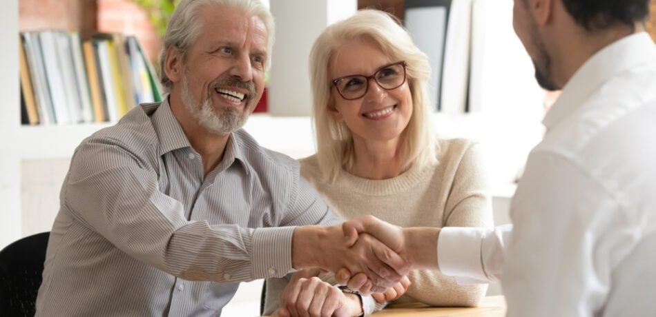 An older couple meets with a life insurance representative.