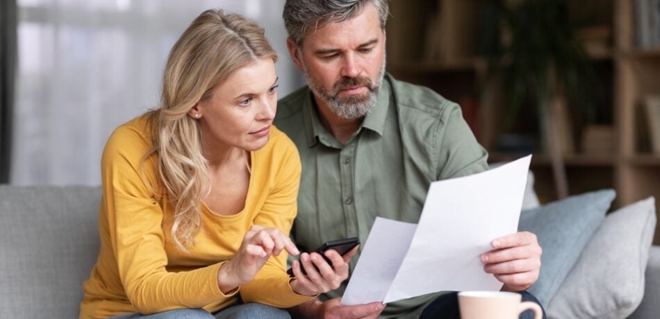 An older couple reviews documents together.