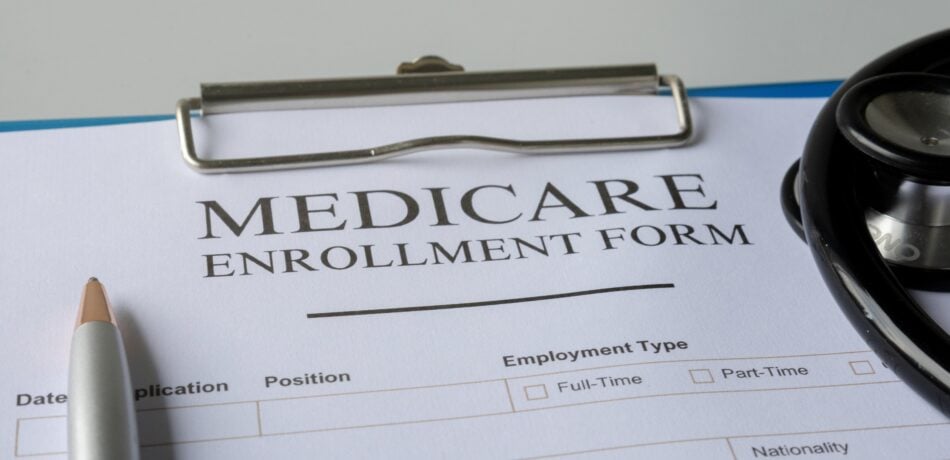 Medicare enrollment form on clipboard.
